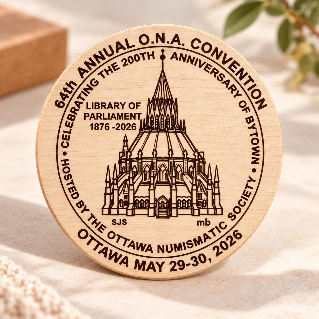 2026 ONA Convention commemorative wooden nickel featuring the Library of Parliament, Bytown 200th anniversary and Ottawa Numi