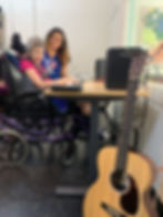 Able ARTS Work resident artist Connie on left playing keyboard with Music Therapist Maria Alvarado
