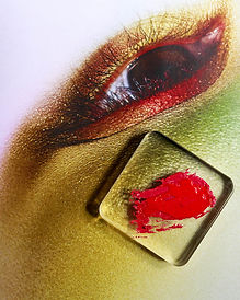 Close-up of a hand holding a gold glitter high heel – luxury footwear detail shot.