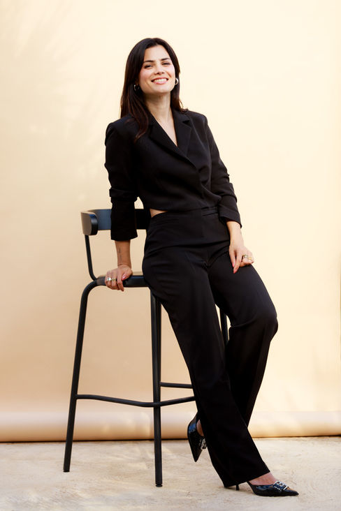 Seated studio portrait in black outfit for personal branding