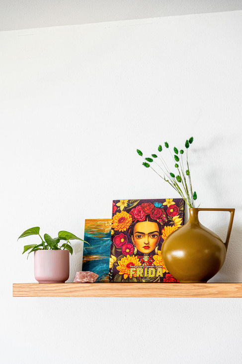 Living room with modern blue sofa and orange decorative elements