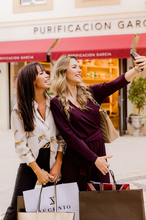 Friends walking and talking outside Purificación García store