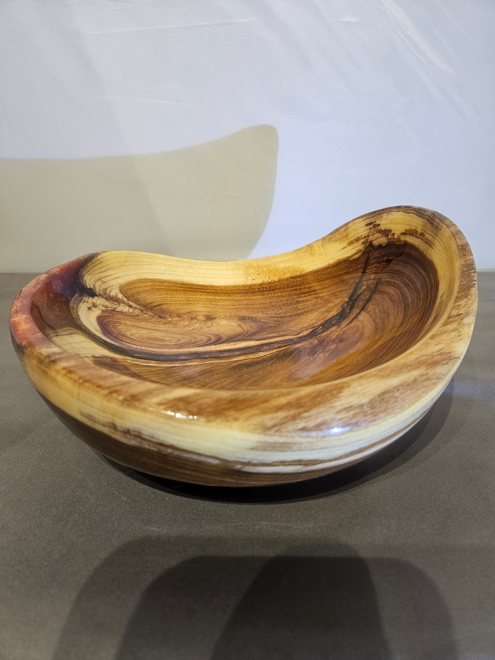 a wooden bowl is sitting on a table