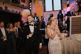 Couple on stage during wedding ceremony with live band and guests
