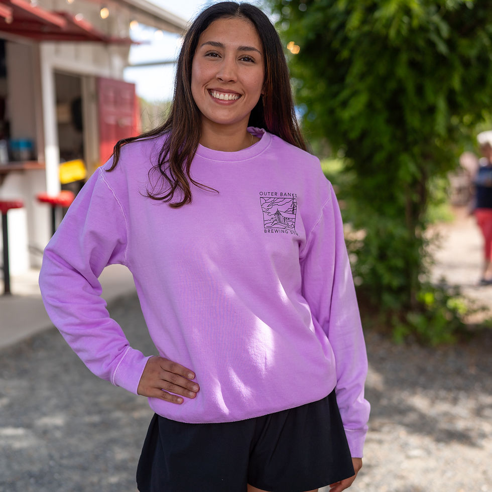 Woman smiling in a purple Beer Guy OBBS sweatshirt.