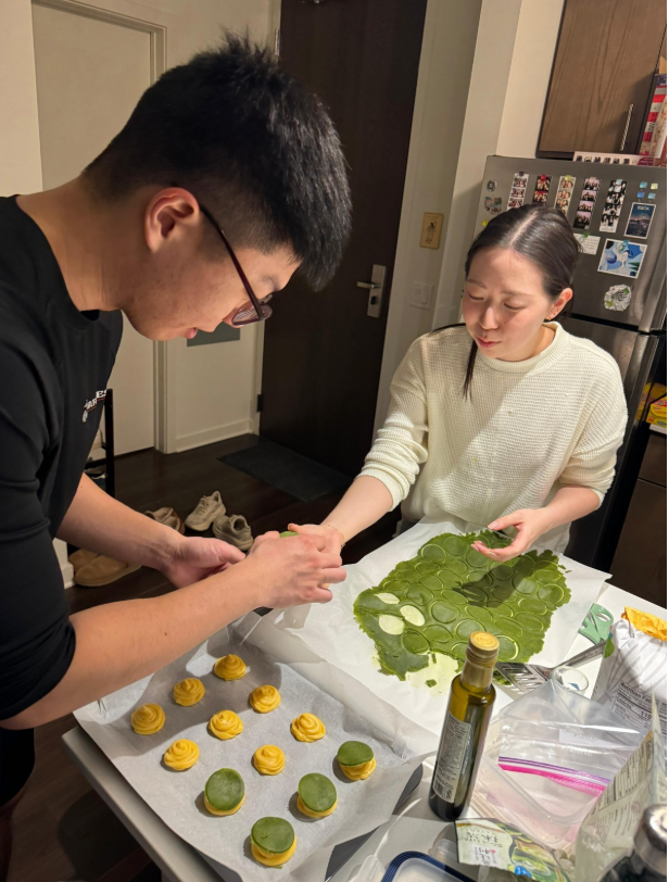 JaeYong Ju (MMM '27, left), Irina Liu (2Y '27, right) top their choux pastry with matcha craquelin before baking