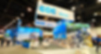 Overhead view of CDE at CONEXPO exhibition stand showing large printed graphics, overhead banner and seating area