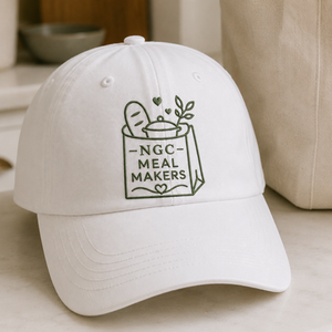 White cap with NGC Meal Makers logo design embroidered on the front.