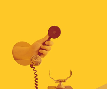 person holding black rotary telephone_ed