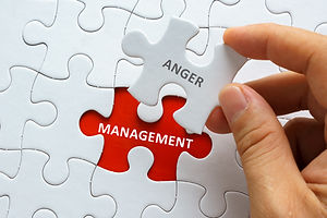 Hand holding piece of jigsaw puzzle with