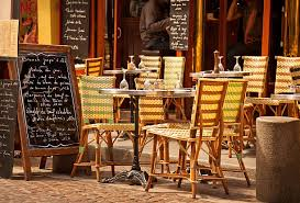 Sidewalk Frame signs beside a restaurant table