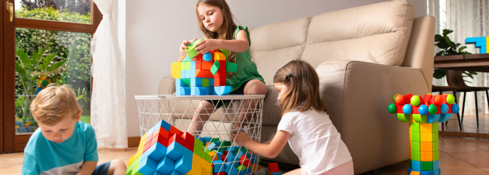 Children playing with geomag toys