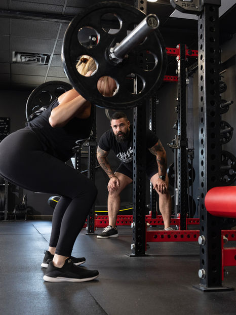 Strength Coach and Personal Trainer Ryan Perreault coaches a squat session