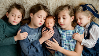 Four big sisters pose with their baby brother
