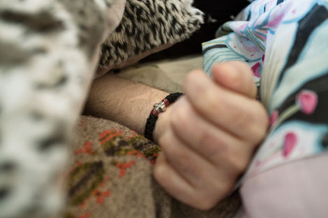 Relatives caring for a terminally ill patient, struggling to provide comfort and quality of life in the final stage.