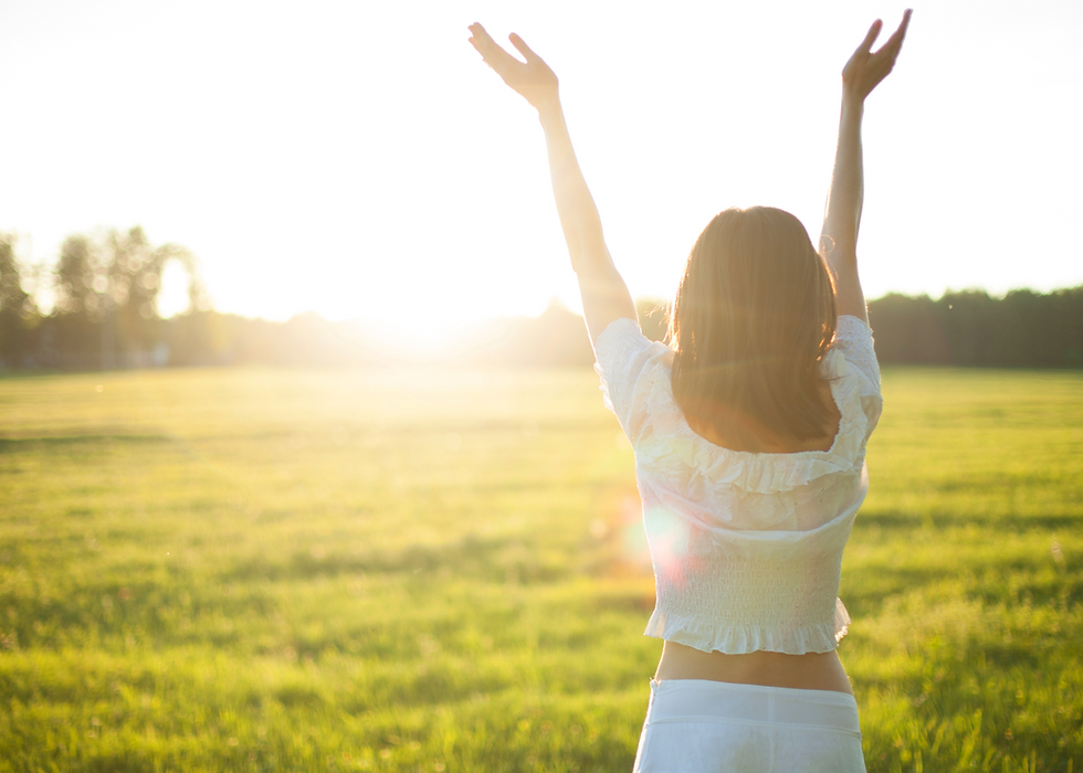 woman standing in the sunlight could be enjoying benefits of light therapy