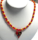 red and yellow beaded necklace with Murano style heart pendant.