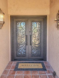 A double square entry door with Oil Rubbed Bronze powder coat, Glue Chip glass pattern, and custom pull #3.