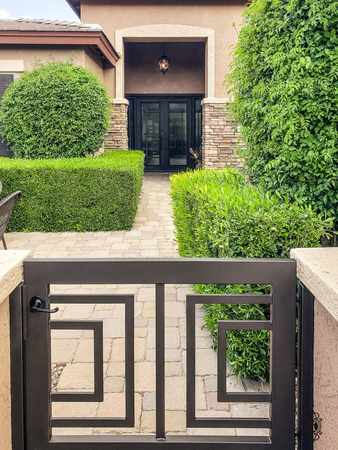 A double square with side lights entry door with Black powder coat, Reeded glass pattern, and custom pull #8.