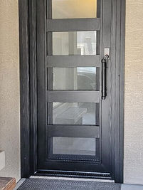 A single square entry door with Oil Rubbed Bronze powder coat, Clear glass, and custom pull #4.