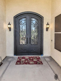 A double eyebrow arch entry door with Oil rubbed Bronze powder coat, Rain glass pattern, upgraded kick plate, and custom pull #7.
