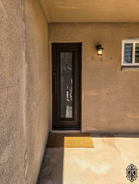 A single square entry door with Rust Texture powder coat, and Acid Etch glass. This entry door is upgraded with 5" door shell and custom pull #14.