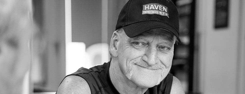 Howie, a Haven Toronto client, smiling while playing cards