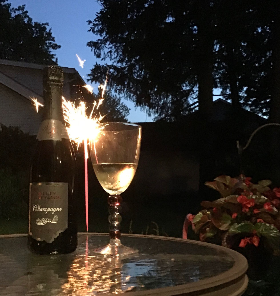 Wine bottle and glass in front of sparkler