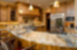 rustic kitchen with golden-hued granite countertops wood cabinetry and warm lighting accents
