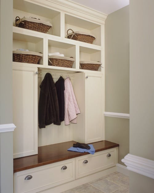 Custom mudroom cabinetry with seating, storage drawers, and coat hooks