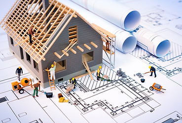 Cartoon house being built with blueprint