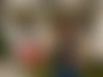 Woman standing in front of a home next to a sold sign