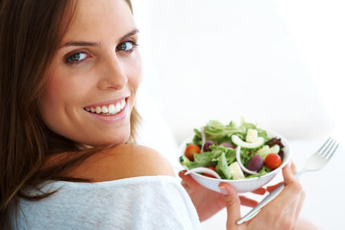 Woman smiling with salad