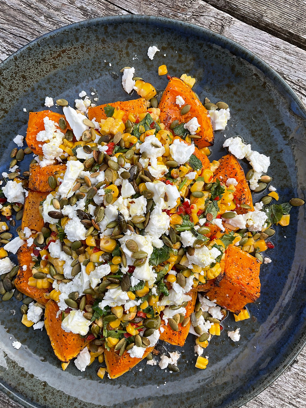 Salad of roasted butternut squash with sweetcorn, herbs, feta & pumpkin seeds