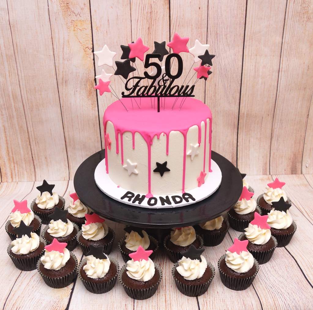Pink, black and white drip cake with sta
