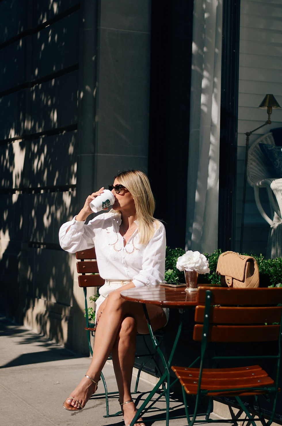 Runner relaxing with a coffee at an outdoor Seattle cafe table after a morning run near Green Lake