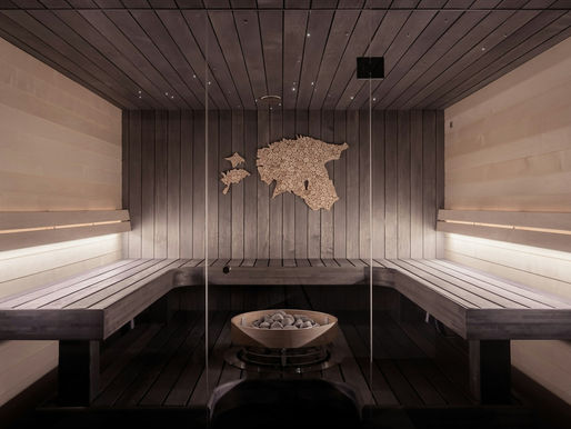 Cold plunge tub next to a wood-lined sauna inside a Seattle contrast therapy studio