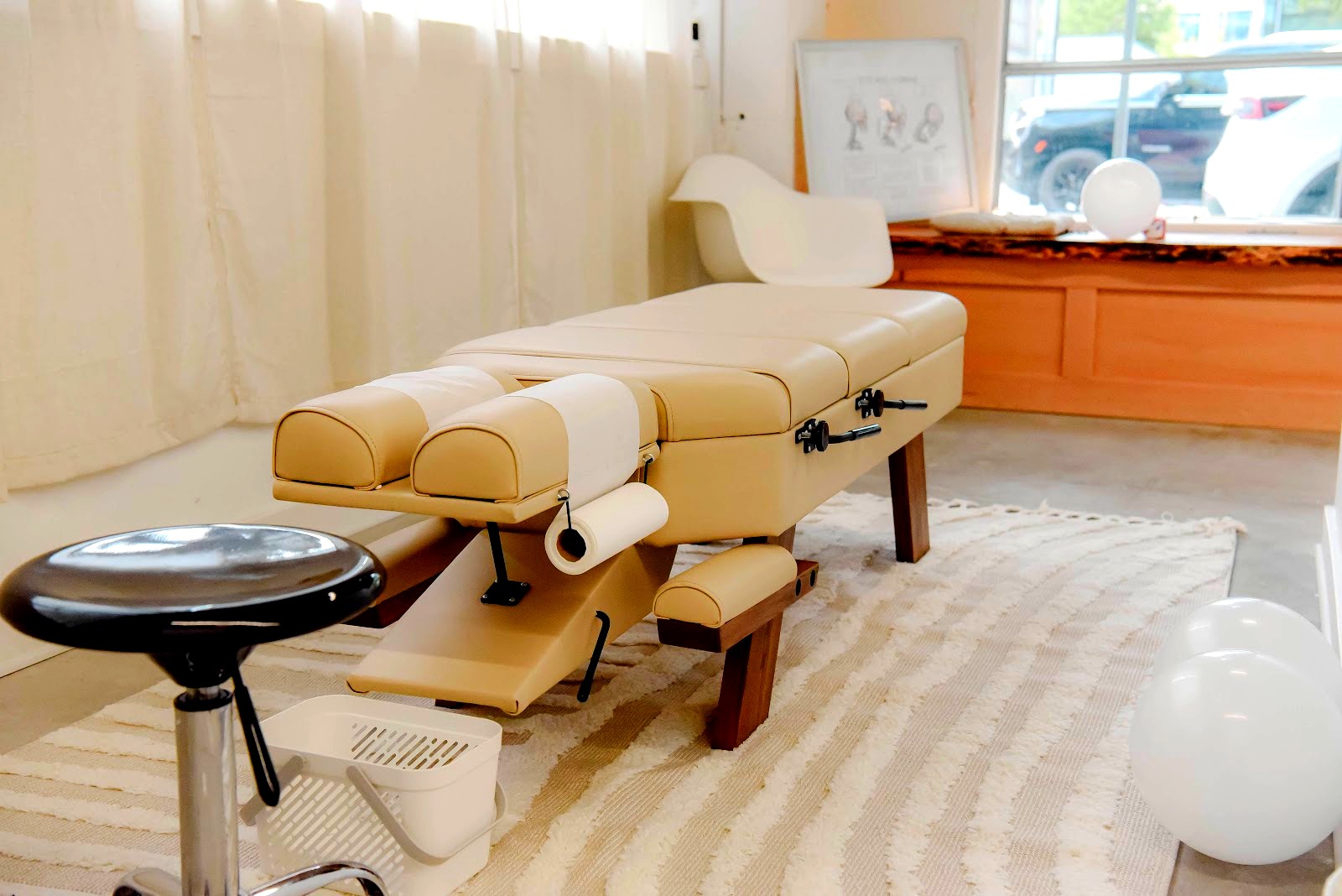 <p>Rooted Chiropractic and Rehab opened in South Lake Union in 2025, founded by Dr. Tarm Leamphan at 771 Thomas St. It arrived built for the neighborhood it sits in: an evidence-first pitch aimed at South Lake Union's desk-bound tech workforce rather than a general chronic-pain caseload.</p>
<p></p>
<figure><img src="https://static.wixstatic.com/media/626360_ada91854ec4d4216a01a120f1ab8cbc5~mv2.jpg" alt="Chiropractic treatment/adjustment table in a treatment room with a spinal anatomy chart on the windowsill"></figure>
<p></p>
<p>The practice calls its clients "practice members," a small language shift that signals a larger one. Treatment starts from a root-cause premise, tracing symptoms back to nervous system function rather than chasing pain point to pain point. The toolkit backs that framing up. Chiropractic adjustment sits alongside myofascial release therapy, kinesiology taping, and active rehabilitation, plus the Graston Technique: instrument-assisted soft-tissue work performed with stainless steel tools instead of hands alone. It reads clinical, not new-age.</p>
<p></p>
<p>The hours match the demographic too. Monday, Wednesday, and Thursday run 8 a.m. to 1 p.m. and again 3 to 6 p.m., split around a gap that lines up with midday meetings and lunchtime workouts. Tuesday and Friday close at 1 p.m. Weekends are closed, Saturday available by appointment only.</p>
<p></p>
<p>Online, the clinic leans on team photography and staff-forward posts rather than stock wellness imagery, closer to a studio's visual register than a strip-mall chiropractor's.</p>
<p></p>
<p>No pricing is published anywhere online. Rooted leads with the method instead of the number.</p>
<p></p>
<figure><img src="https://static.wixstatic.com/media/626360_951192e80aff42a6964179badc37c763~mv2.jpeg" alt="Storefront exterior with glass door showing the '77' street number and ROOTED leaf-logo decal, 771 Thomas St"></figure>
<p></p>