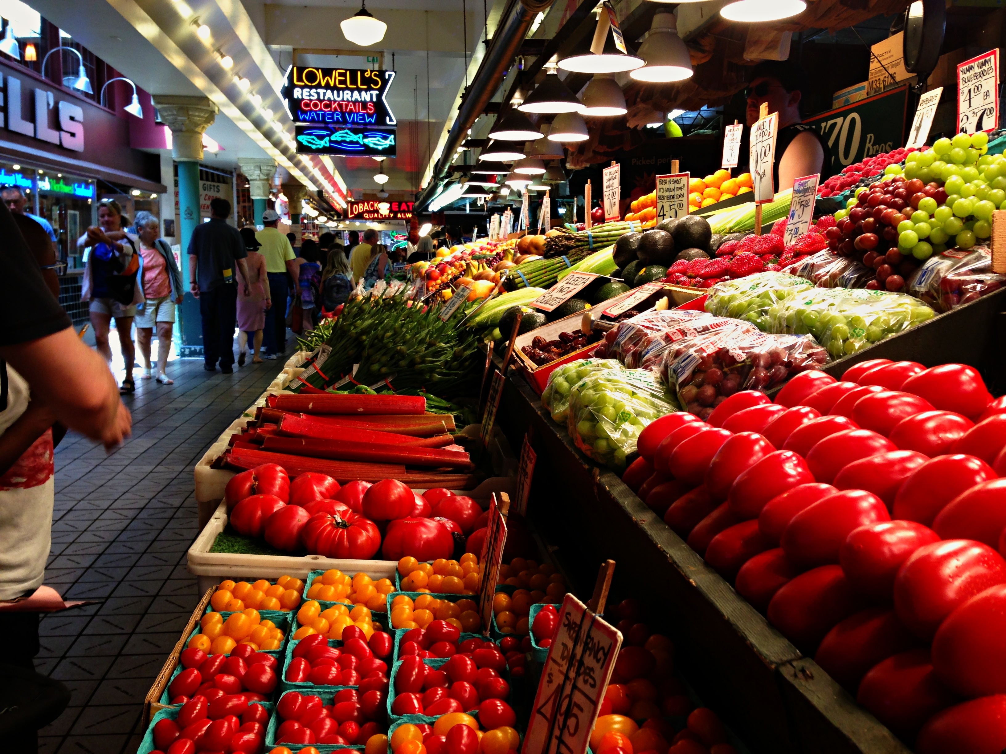 <h2>The Highstall Lee Family Farm's Five Acres Never Had</h2>
<p>Christy and Xiong Lee run a produce highstall in Arcade No. 2 at Pike Place Market, at 1509 Pike Place in Seattle. Their family didn't hold that space two decades ago. Lee Family Farm's own account traces its start to 2001, when Lue and Pha Lee sowed the farm's first seeds on five acres in Kent, Washington. Pike Place Market's vendor page names only Pha Lee as the founder. The two closest sources to the farm don't agree on who started it, and neither resolves the other. What both agree on is where that first plot sat, in the Kent Valley south of Seattle, and how small it was next to what the farm has become.</p>
<h2>The First Harvests Never Reached a Market</h2>
<p>The first harvests never reached a market. Lee Family Farm's own history says the earliest crops were given to the Asian Counseling and Referral Service food bank in Seattle's International District, with Pha Lee volunteering there weekly while the farm was still finding its feet. It fits a farm that started five acres wide and gave much of what it grew away before it ever sold any of it.</p>
<h2>Forty Acres and a Generational Handoff</h2>
<p>The farm works nearly 40 acres in the Kent Valley now, up from the five it started on twenty-five years ago, according to its own homepage. The handoff to the next generation is fuzzier. Its about page says Christy and Xiong Lee, the second generation, took over farm management roughly five years after the 2001 start, putting the handoff around 2006, while Pike Place Market's vendor page describes the operation more loosely, as second-generation Hmong-owned and cultivating those nearly 40 acres, without giving a year for when that generation took charge. The acreage grew in stages nobody dated precisely, and so did the handoff that came with it.</p>
<h2>A Produce Stall Where Hmong Farms Mostly Sell Flowers</h2>
<p>Hmong farmers make up close to 60 percent of the farm vendors at Pike Place Market, and some have sold there for decades longer than the Lees. Xee Yang-Schell's Yang Farm has operated at the market since 1987. See Lee Garden joined the market's Indochinese Farm Project in 1986, a county-backed program that started in 1982 with six refugee families and eventually helped more than 80 into flower growing at the market, a program Lee Family Farm's 2001 start had no part in. Both operations built around flowers, without a dedicated produce highstall. Lee Family Farm's own case runs on bok choy, yu choy, mustard greens and watercress instead. Whether the farm belongs to the Washington Hmong Farmers Cooperative, a group formed in 2022 that now counts 14 member farms, is not confirmed by any source available.</p>
<h2>The Kent Farm Behind the Highstall</h2>
<p>The market stall is one outlet for a farm that still operates from 4308 South 212th Street in Kent. Through the growing season, it also runs a u-pick strawberry stand there: Chandler berries in June, the everbearing Albion variety later in summer, priced at $4 a pound to pick yourself or $4 to $38 for baskets already picked. That stand is closed right now. The farm's own site marks it to reopen in 2026, a reminder that the Seattle highstall is one of several ways the family sells what it grows.</p>
<h2>What the Greens Are, By the Farm's Own Words</h2>
<p>The highstall's case is built around bok choy, yu choy, mustard greens and watercress, which Pike Place Market's own vendor page describes as chemical and pesticide free. Neither the farm's website nor its market listing claims anything beyond that: no nutrient counts, no performance language, nothing pitched at anyone training for anything. The same stall sells handcrafted dried flower arrangements, wreaths and small bouquet magnets. The greens themselves move through other Seattle-area farmers markets, specialty grocers and restaurants, well beyond the Pike Place case. For a reader who lifts weights or runs and wants more greens on the plate, that's the entire pitch. Fresh. Grown without chemicals. Sold by the family that grew them. Nothing more than that.</p>
<h2>The Highstall in Arcade No. 2</h2>
<p>The highstall itself sits in Arcade No. 2 at Pike Place Market, next to Market Grill, open seven days a week. It is a piece of a business that started by giving vegetables away, and the only piece of Lee Family Farm's story that carries a Seattle street address instead of a Kent one. Twenty-five years after five acres in the Kent Valley, that address reads 1509 Pike Place.</p>