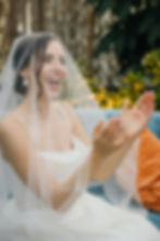 bride wearing gown smiling and clapping