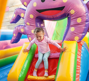 Girl Playing in Bouncy Castle