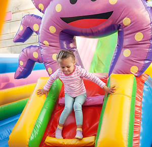 Girl Playing in Bouncy Castle