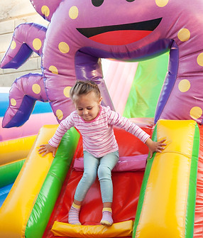 Girl Playing in Bouncy Castle
