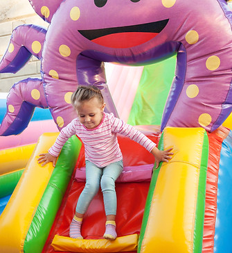 Girl Playing in Bouncy Castle