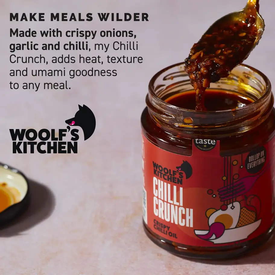 Jar of Woolf's Kitchen Chilli Crunch with text, adding flavor to meals.