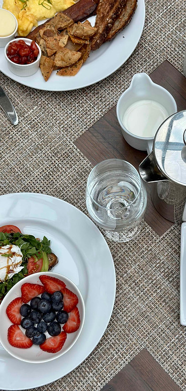 table set for breakfast with coffee and fruit