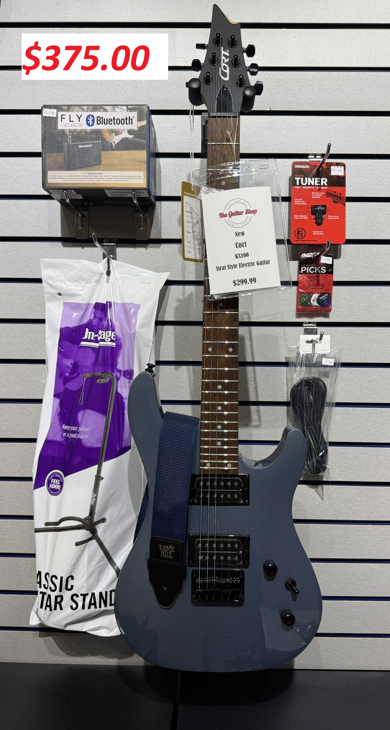A spread of essential guitar accessories including cables and picks.