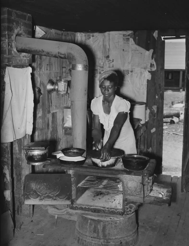 An African American sharecropper woman prepares a meal 1930's
