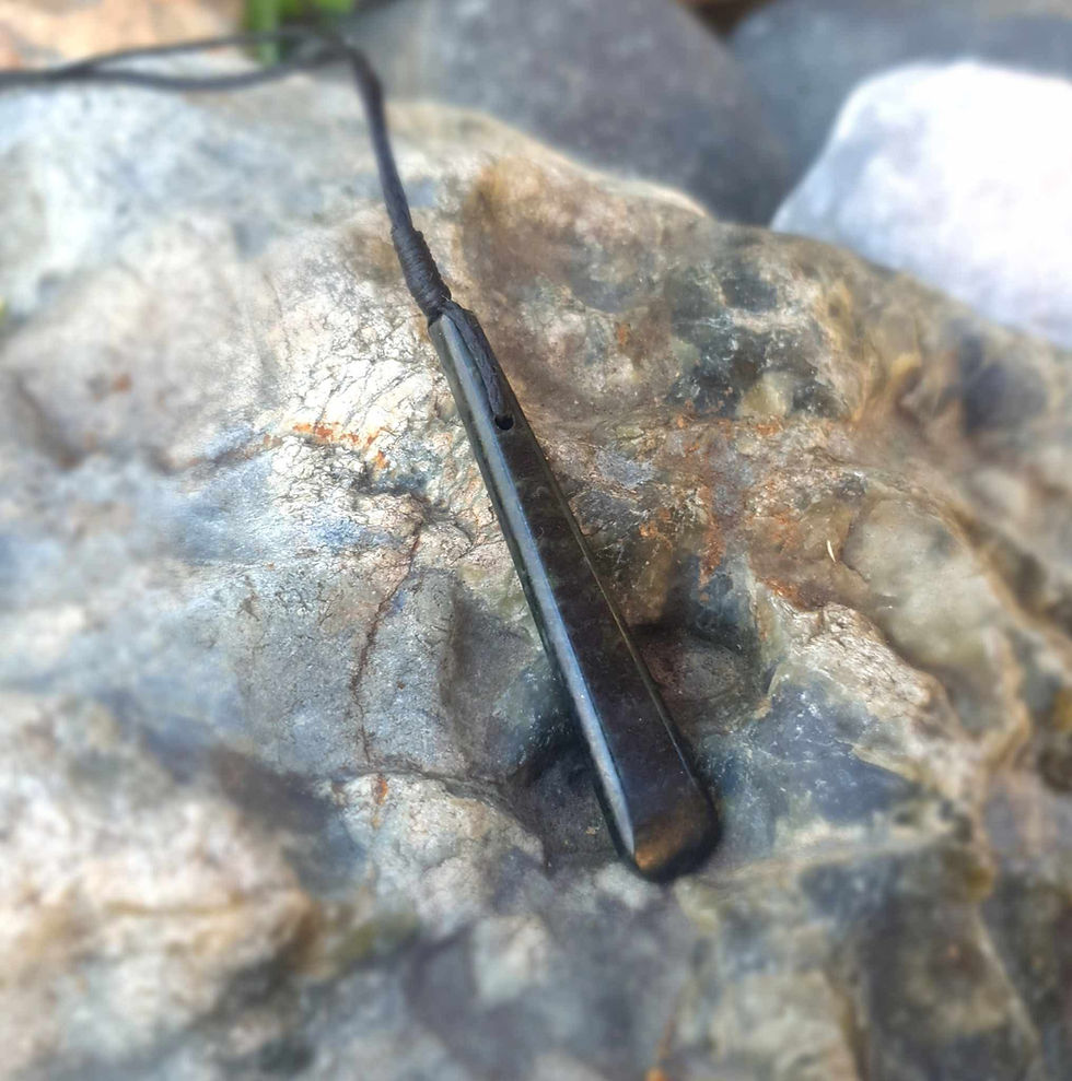 Thumbnail: Side view of slender Douglas Creek Pounamu roimata pendant carved from serpentine jade