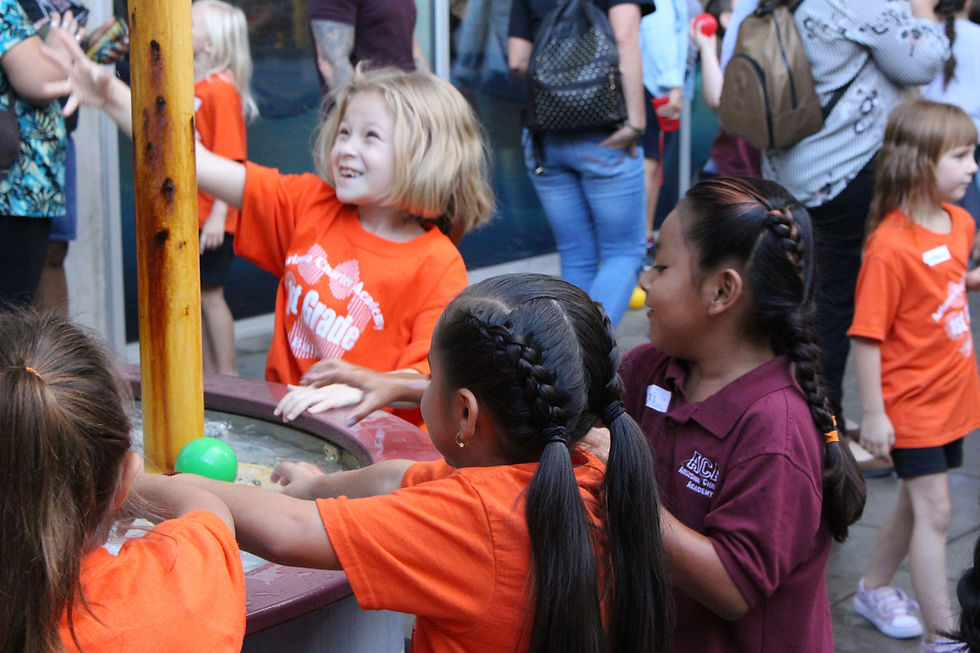 1st graders playing with the water exhibit
